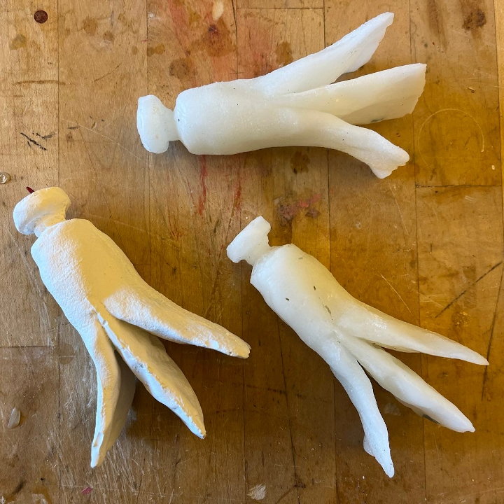 <i>Untitled</i>. Three casts of abstract paint tubes, like peeling bananas, or squid.