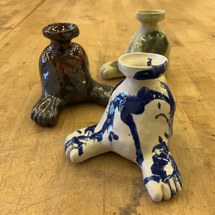 <i>Untitled</i>. An image of three slip casts of custom-designed pots with feet.