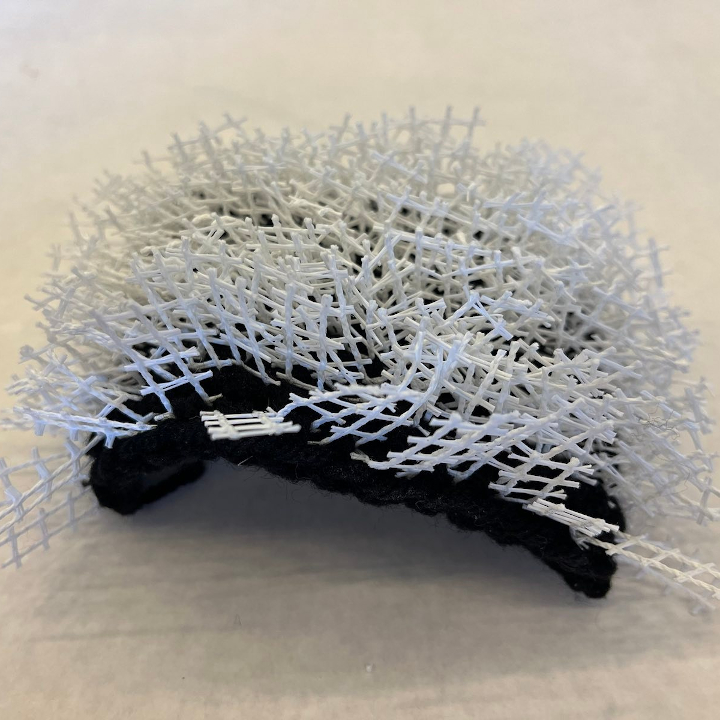 <i>Untitled</i>. A latch hook rug in which I've reversed the roles of yarn and canvas---the yarn forms the base, and the rug canvas is cut up into pieces which form the rug fibres.