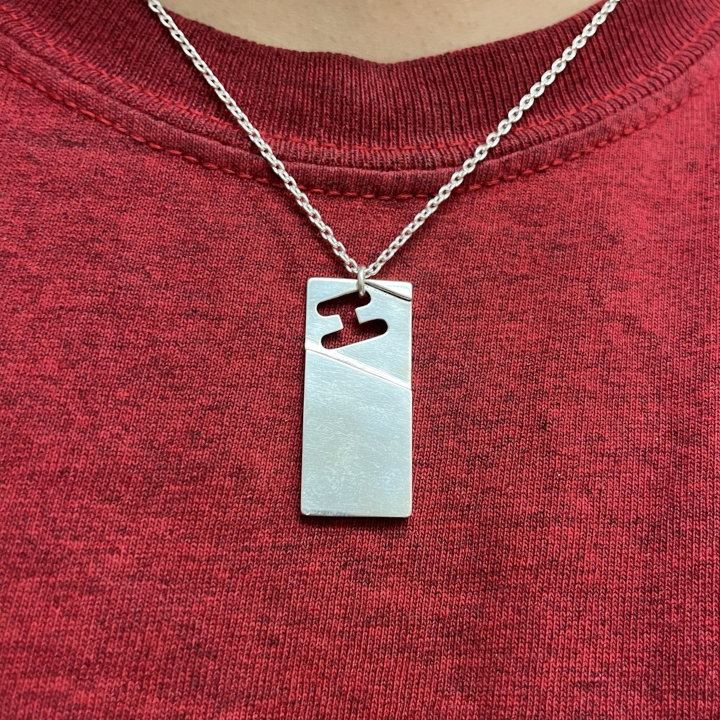 <i>Untitled</i>. An image of an abstract silver pendant.