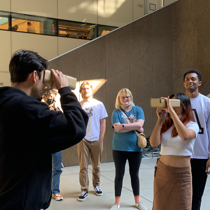 <i>Untitled</i>. Photo of people using my headsets to swap their sense of vision.